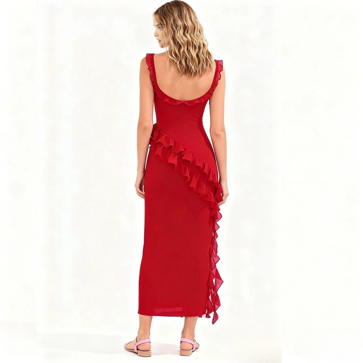 Woman wearing a red Kouvr dress with ruffled details on a white background