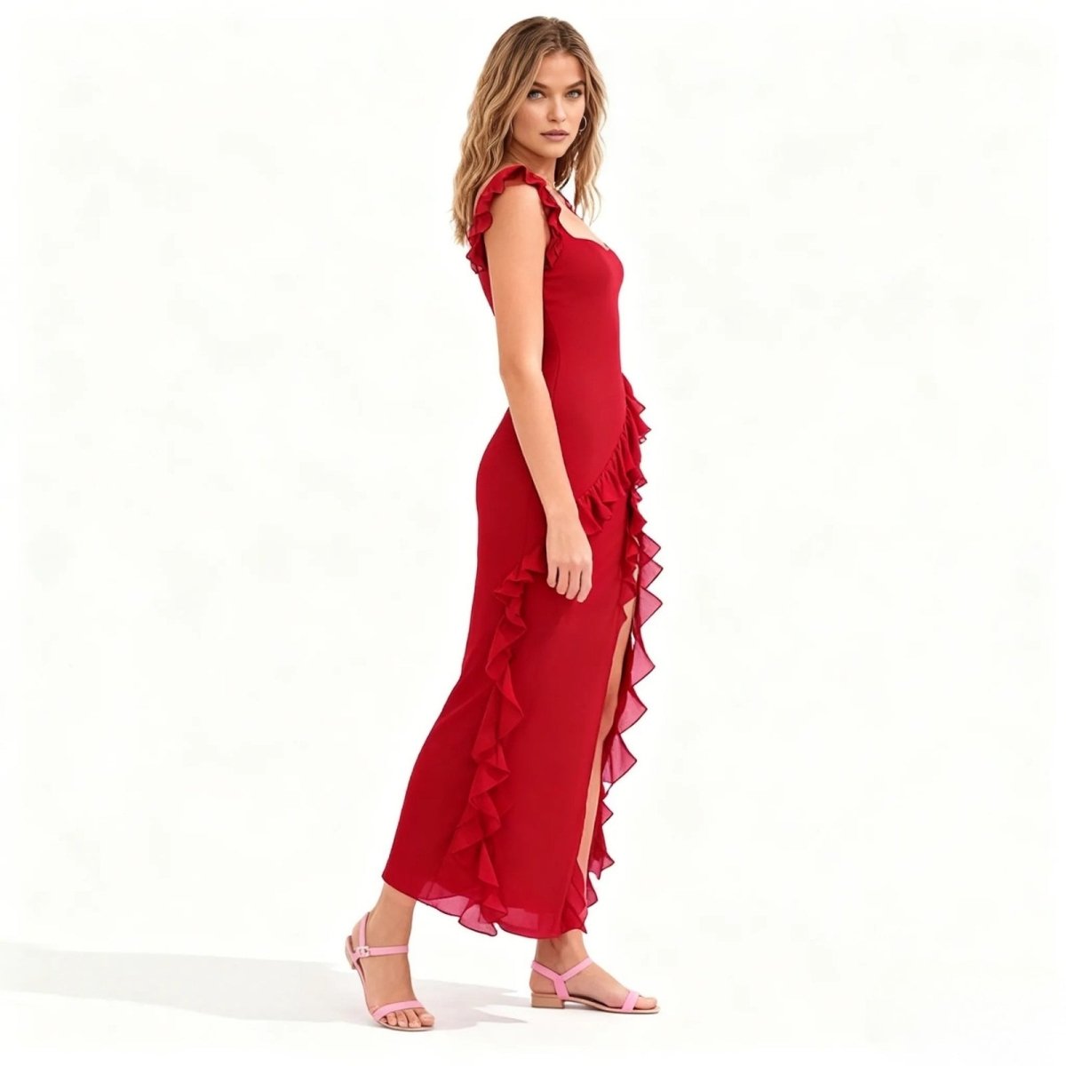 Woman wearing a red Kouvr dress with ruffles on a white background
