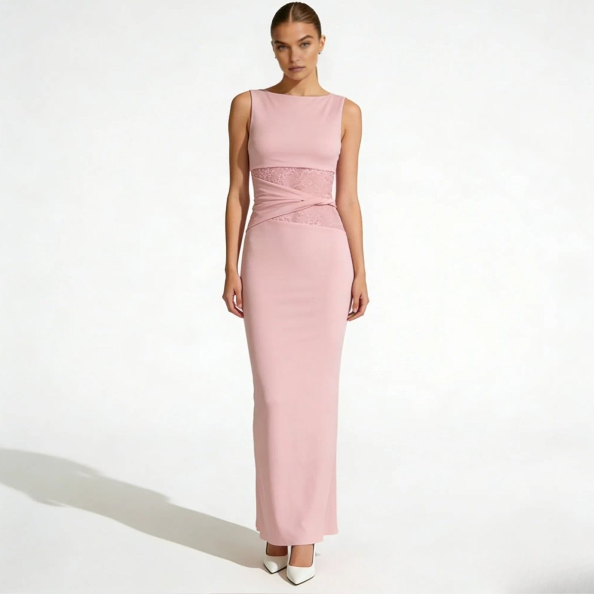 Model wearing the Kouvr Fashion deborah pink sleeveless formal gown with intricate lace waist detail, viewed from the front.