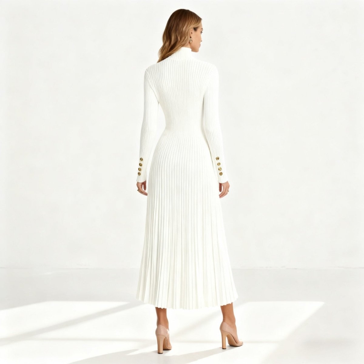 Rear view of the Kouvr Fashion Dianne white midi dress, detailing the fitted ribbed bodice and fluid pleated skirt.