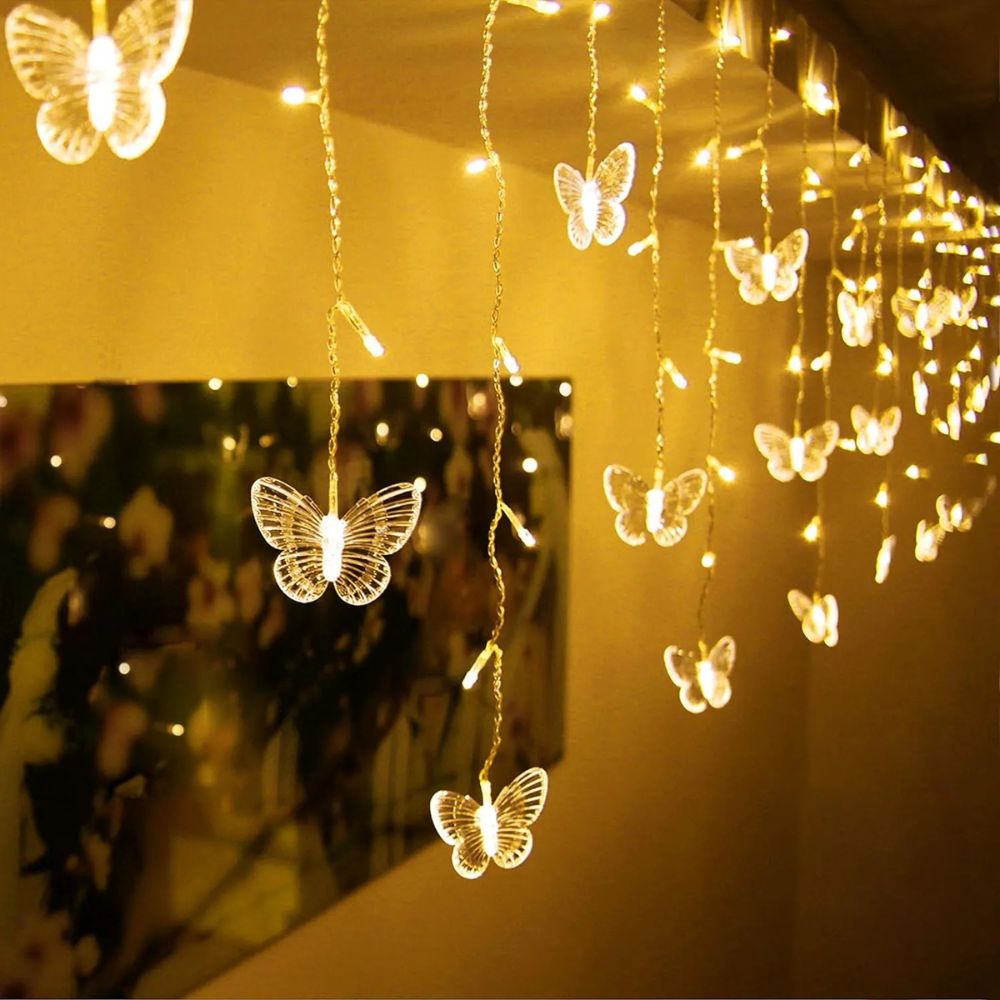 Kouvr Fashion's Fairy Flutter Lights creating a magical, romantic glow over a headboard in a luxury bedroom