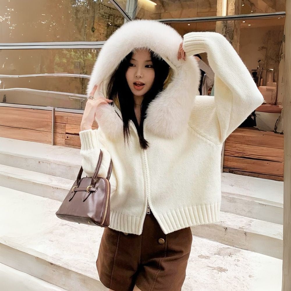 Woman wearing the Kouvr ivory knit hoodie with plush faux fur trim, styled with matching wide-leg pants