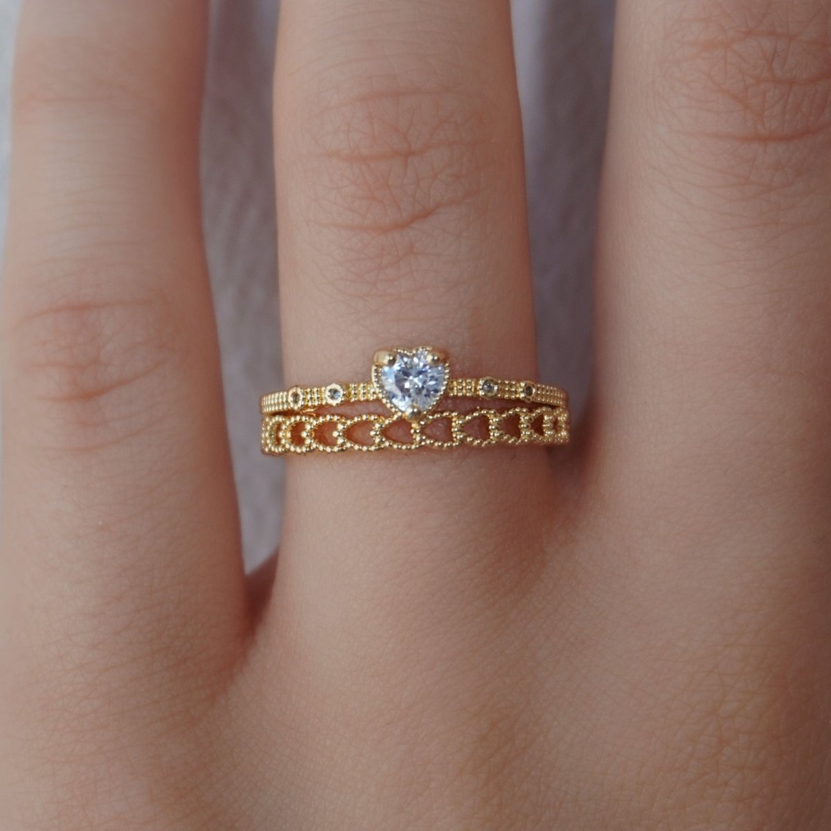 The Kouvr Fionara gold stacking ring set shown as part of a chic, minimalist outfit.