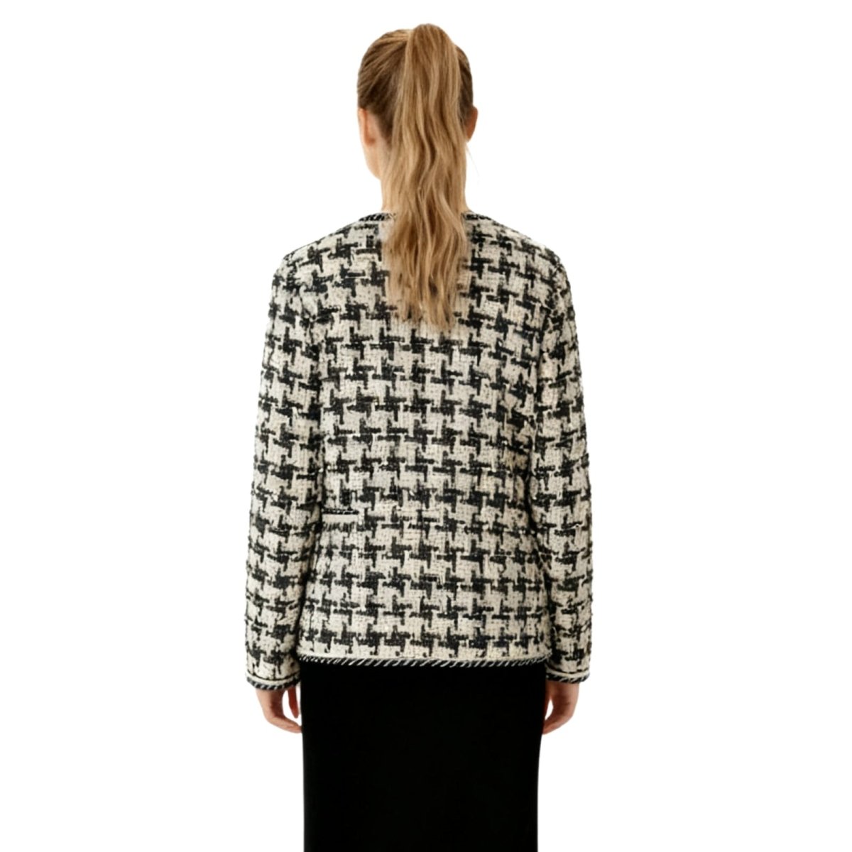 Person wearing a houndstooth patterned jacket on a white kouvr background