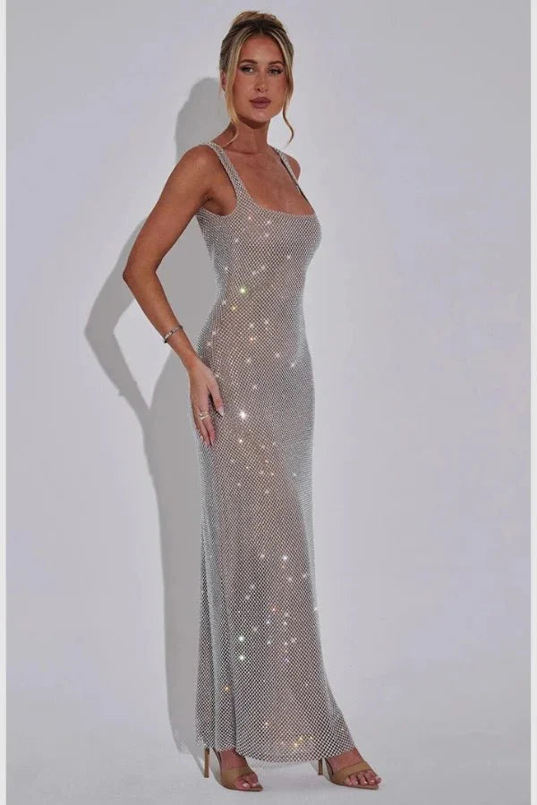 Model wearing the Kouvr Fashion Isabeu Gown, a silver floor-length rhinestone crystal mesh dress with a square neckline