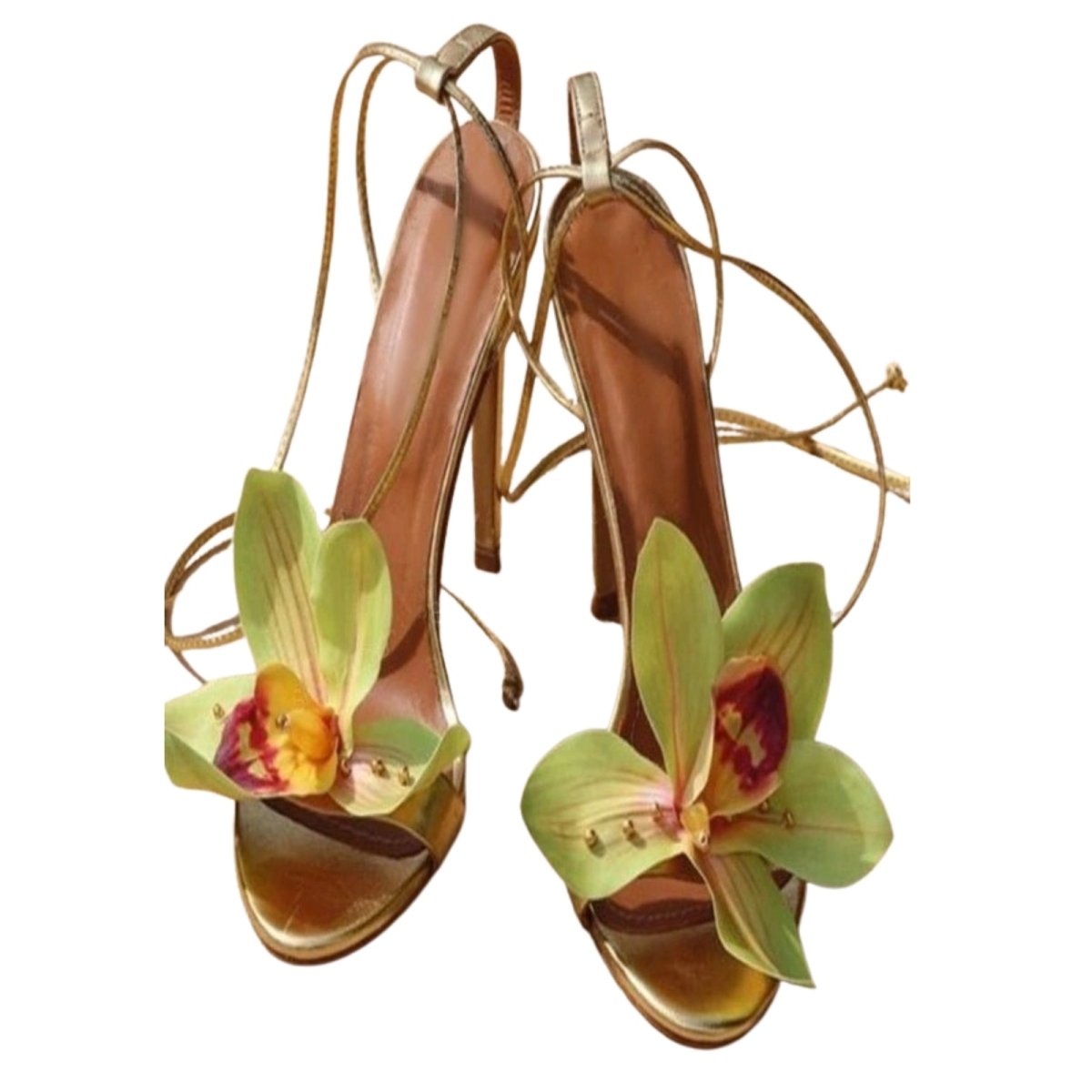 Green heeled with floral embellishments on a white background.