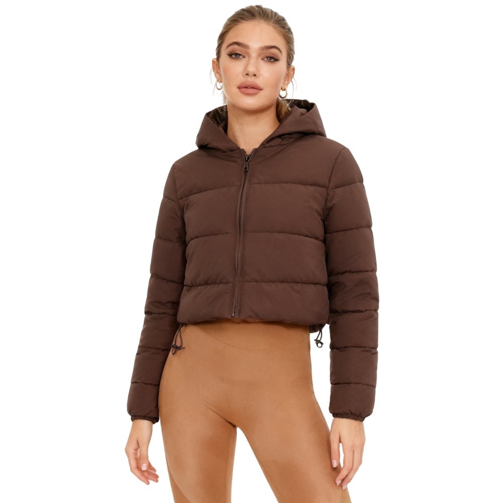 Woman wearing a brown Kouvr puffer jacket on a white background