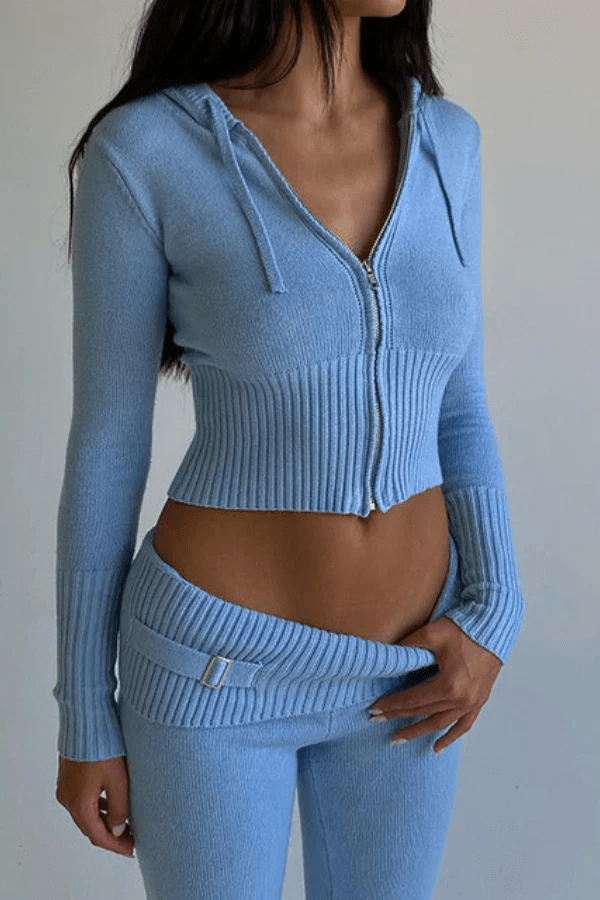 Close-up detail shot of the ribbed knit fabric and waistline on the Kouvr cropped zip hoodie and matching light blue pants.