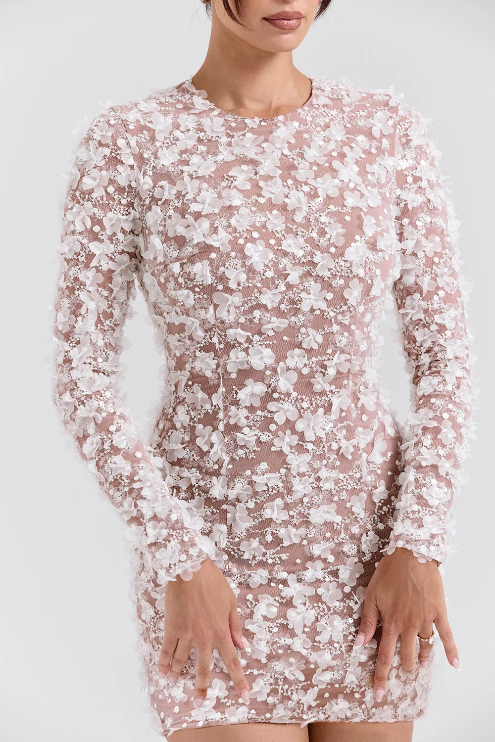 Model wearing Kouvr Fashion white 3D floral appliqué open back mini dress