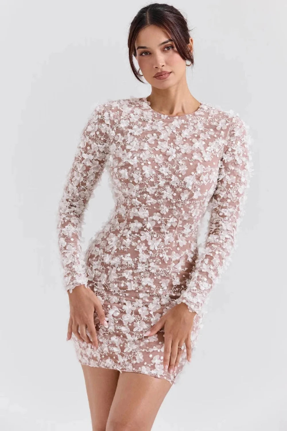 Model wearing Kouvr Fashion white 3D floral appliqué open back mini dress