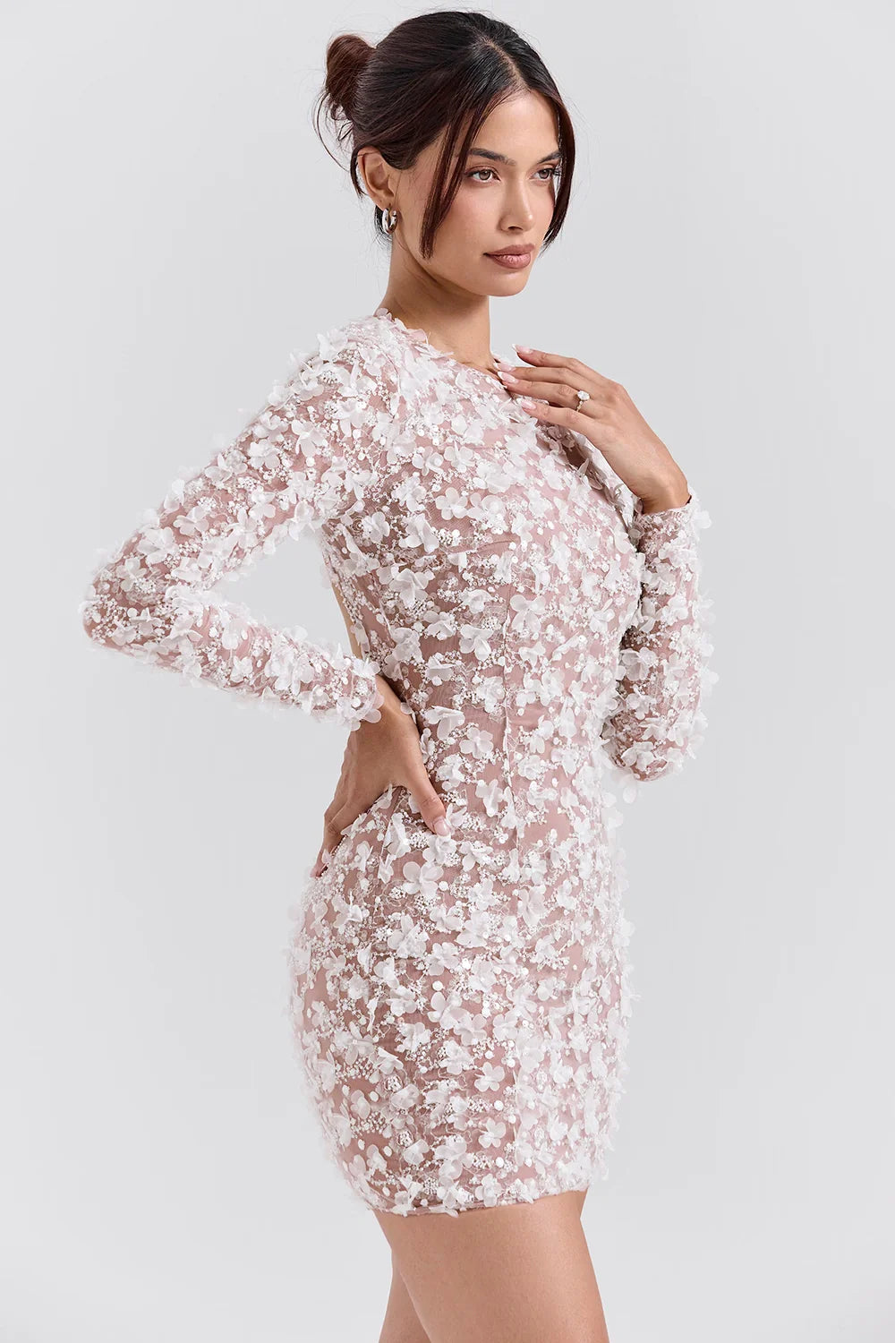Model wearing Kouvr Fashion white 3D floral appliqué open back mini dress