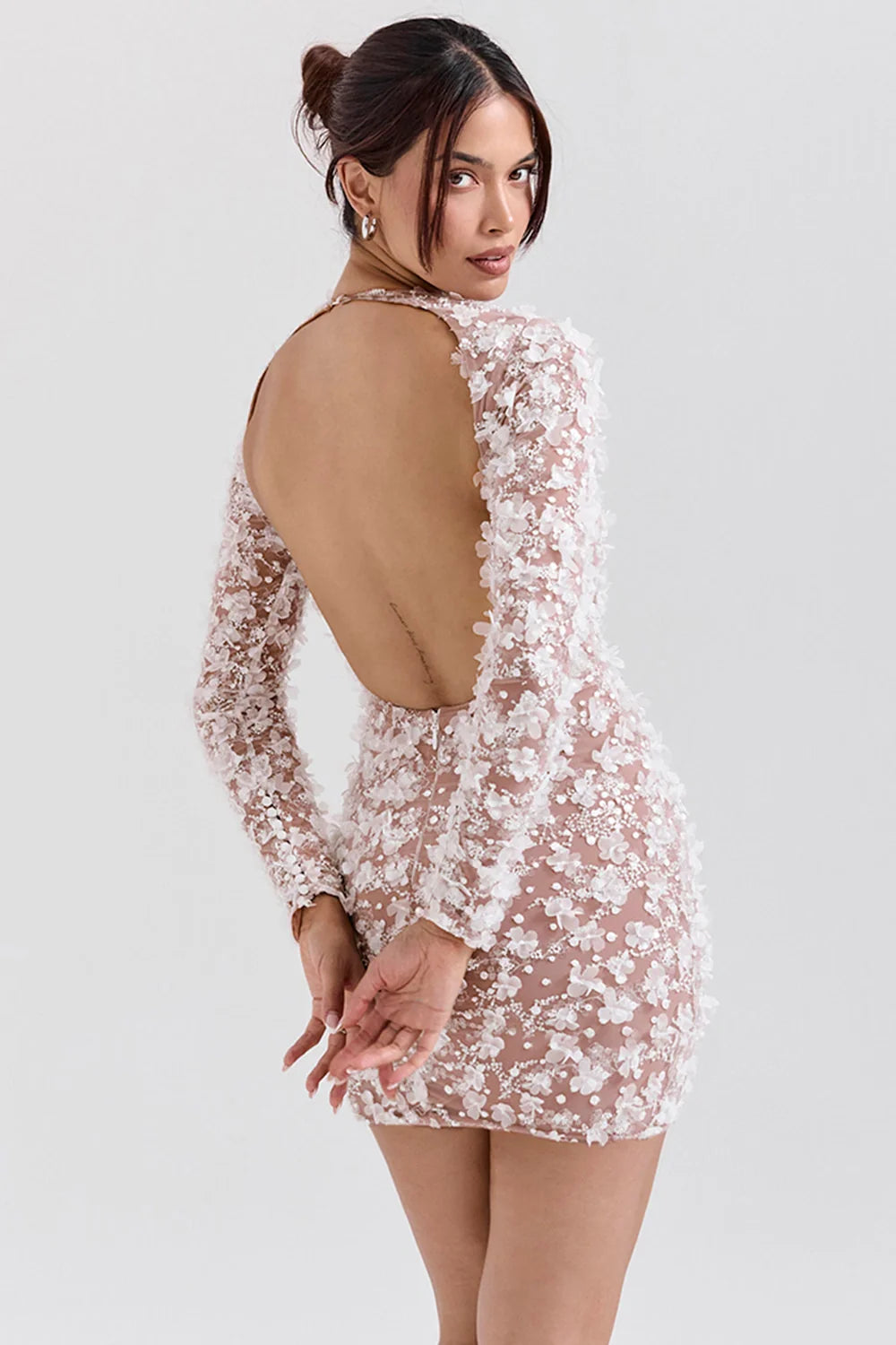 Model wearing Kouvr Fashion white 3D floral appliqué open back mini dress