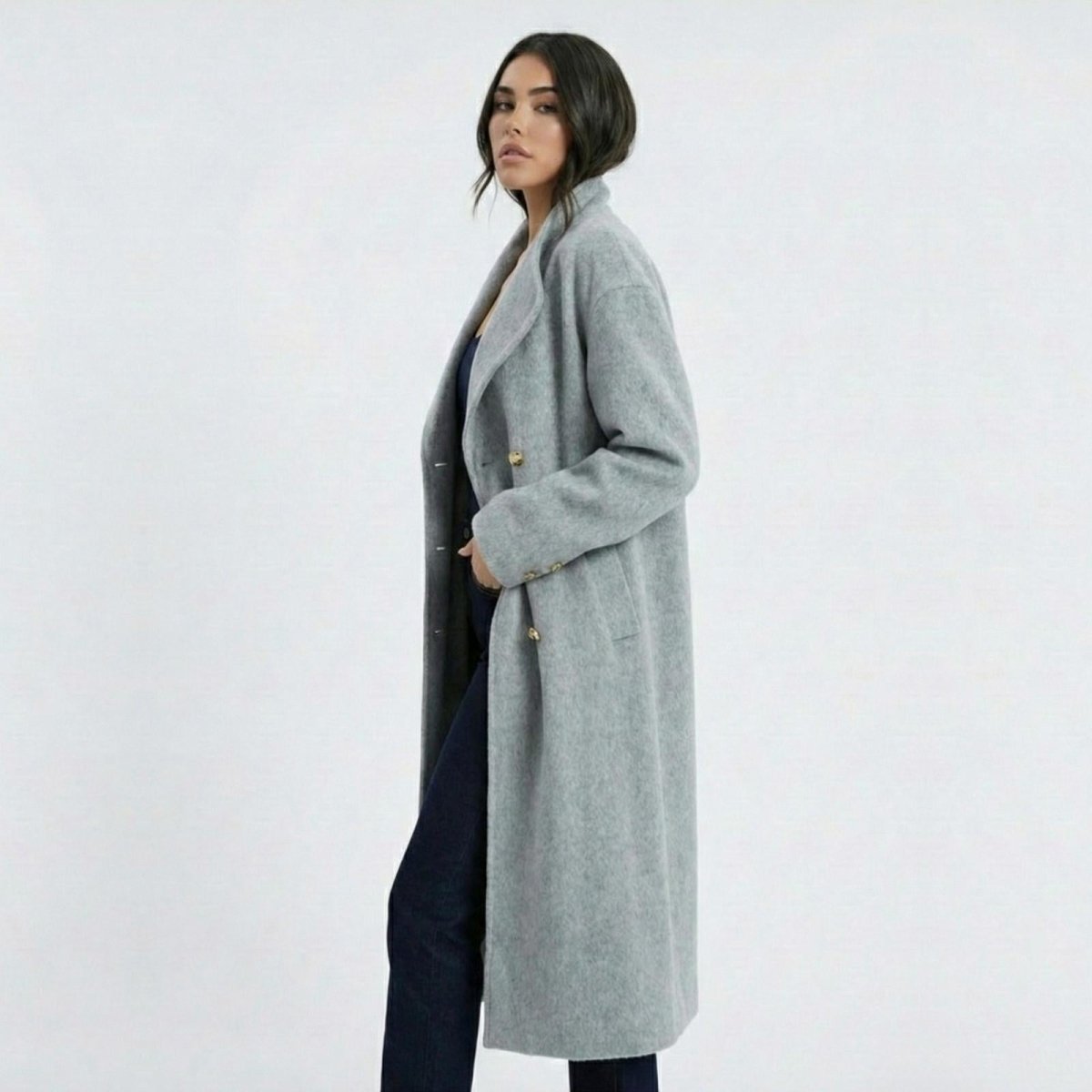 Side profile view of Madison Beer in the Maddie oversized grey winter coat by Kouvr Fashion, highlighting its long silhouette and drape.