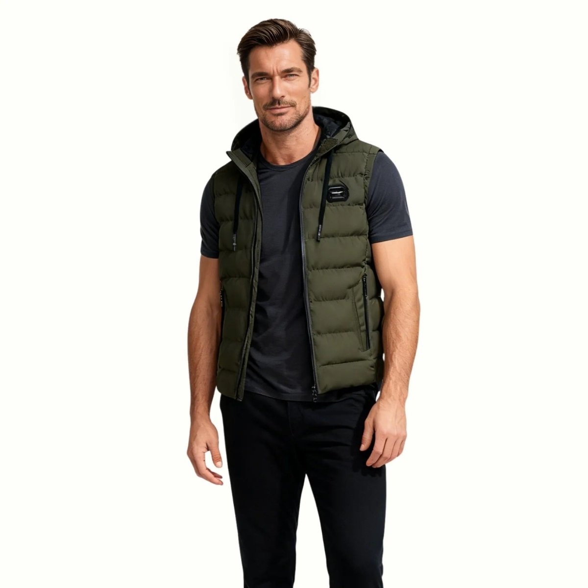 Man wearing the Kouvr Fashion army green hooded puffer vest facing forward against a white background.