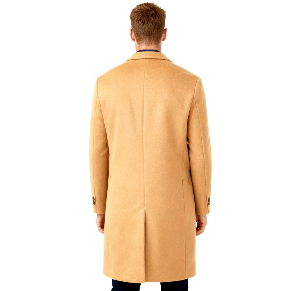 Man wearing a beige Kouvr overcoat on a white background
