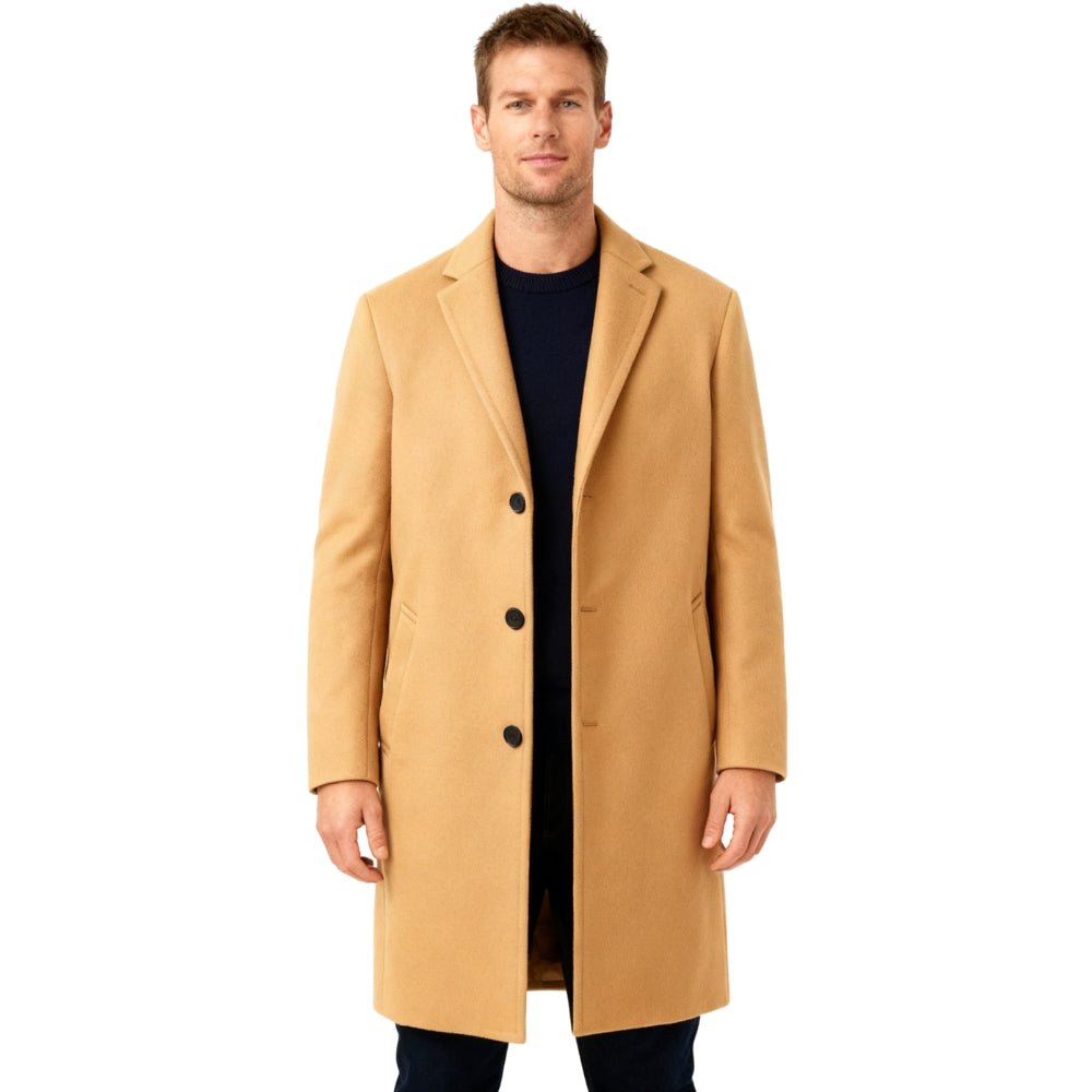 Man wearing a tan Kouvr overcoat on a white background