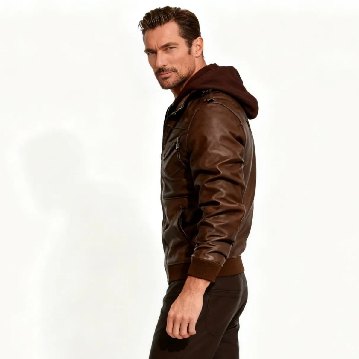 Side profile of a man wearing the slim-fit brown hooded biker jacket from Kouvr Fashion, showing its silhouette.