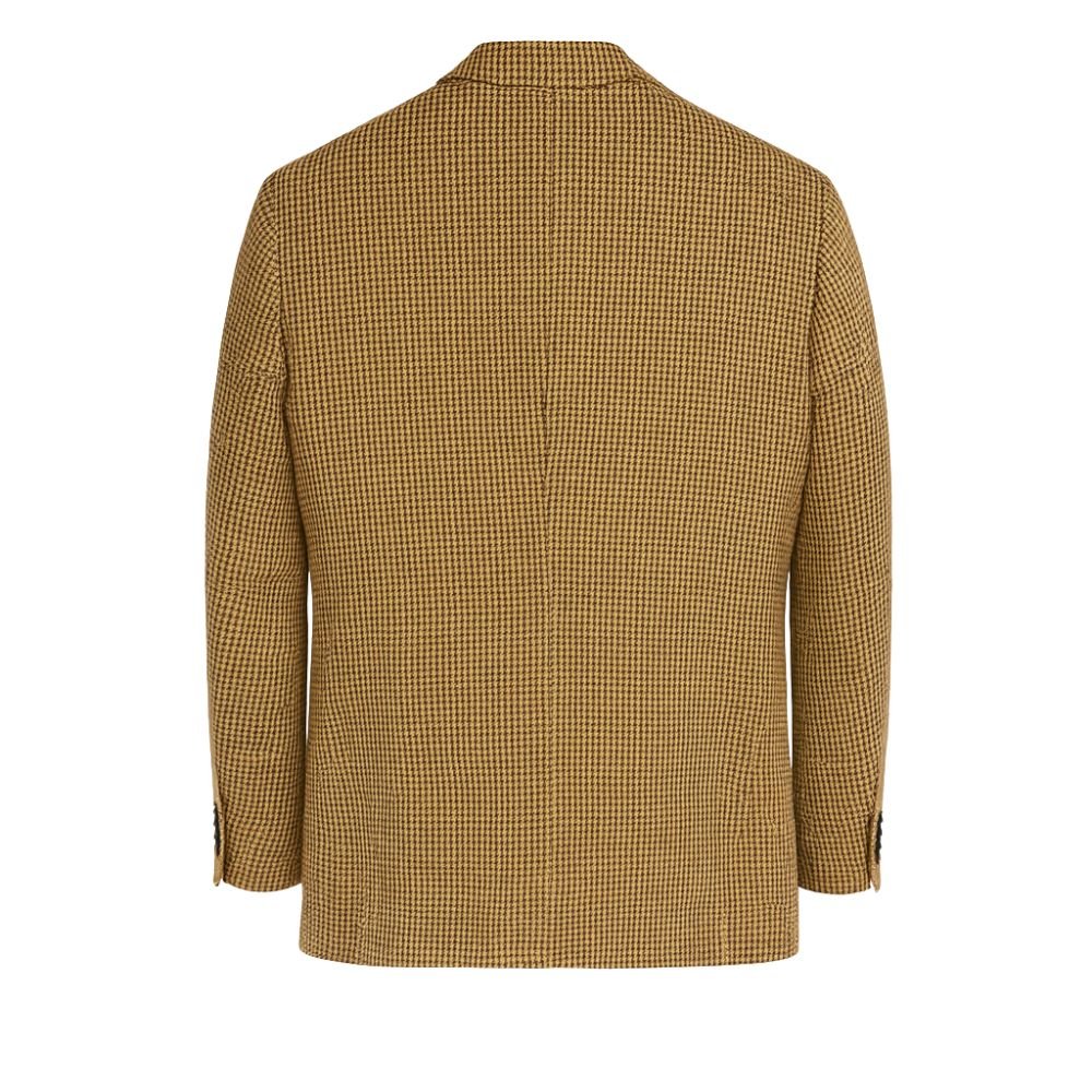 Model wearing Kouvr Fashion brown and black houndstooth blazer with black trousers