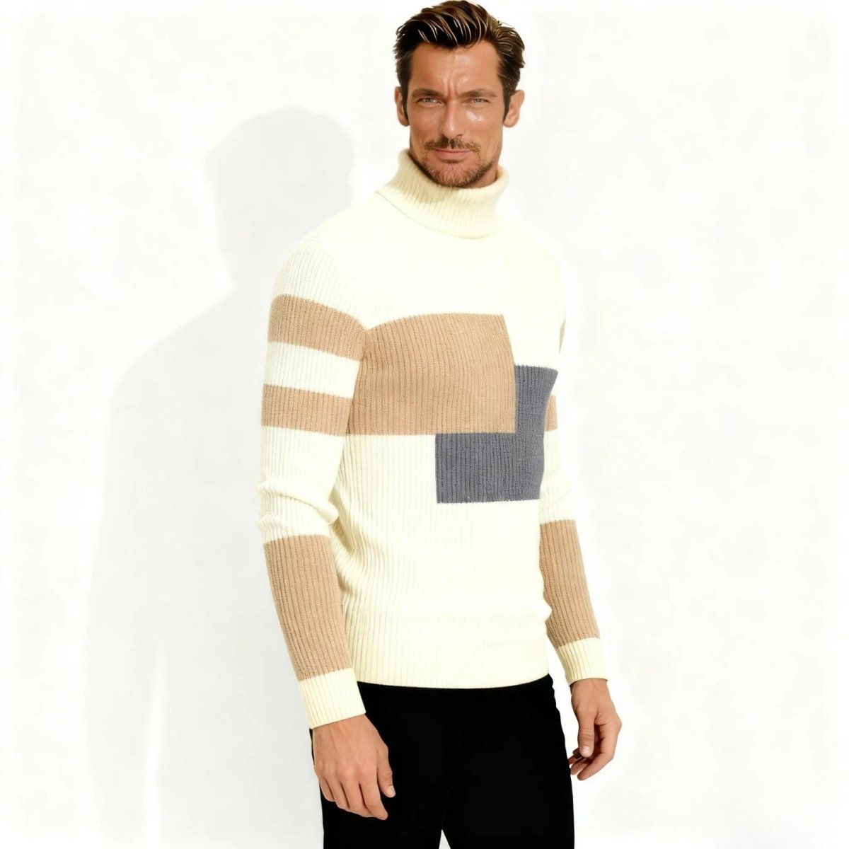 Three-quarter view of a male model in the Kouvr Fashion modernist geometric turtleneck, highlighting the color block design on the chest and sleeves.