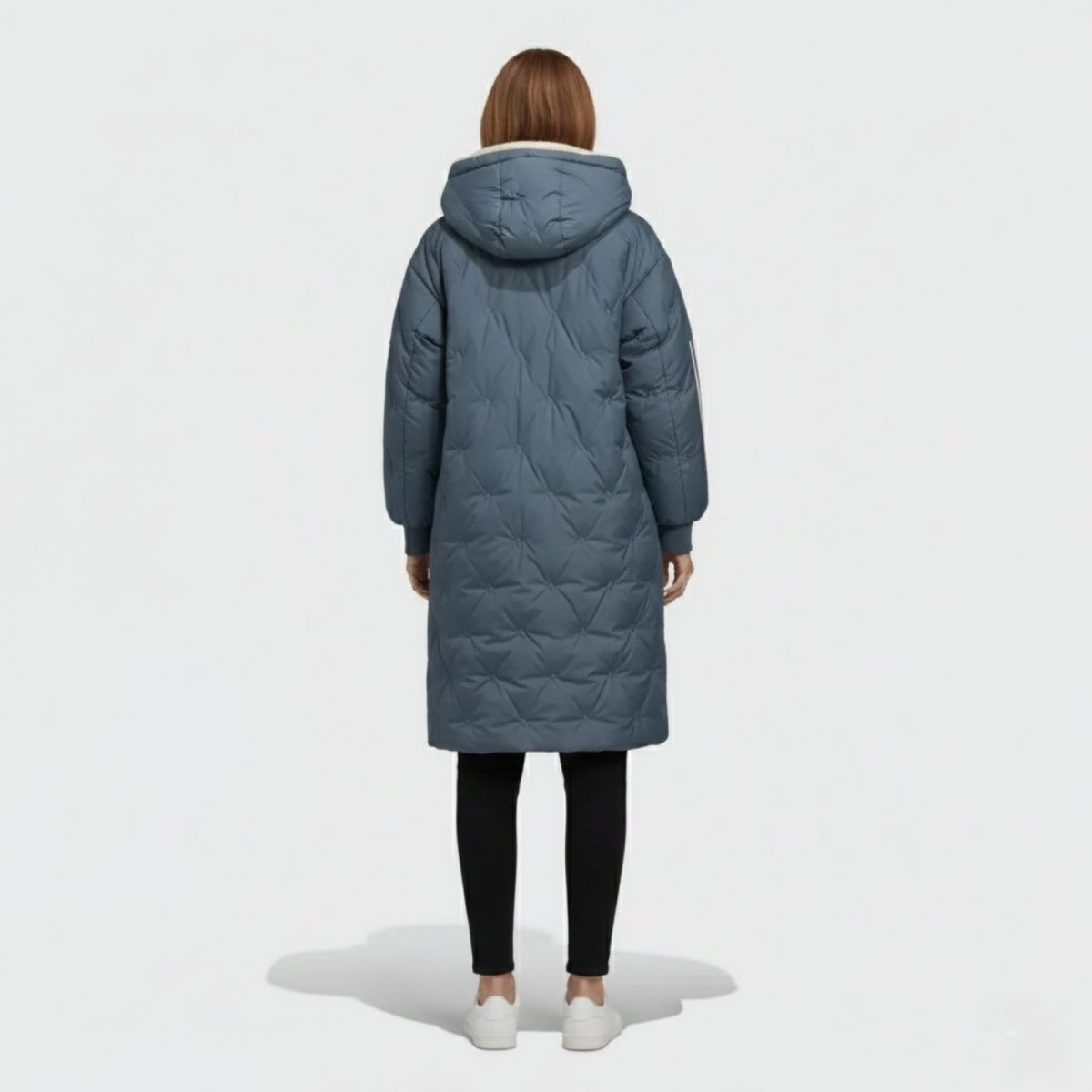 Back view of a woman wearing the Kouvr Fashion Meridian parka, highlighting the diamond quilting pattern and oversized hood.