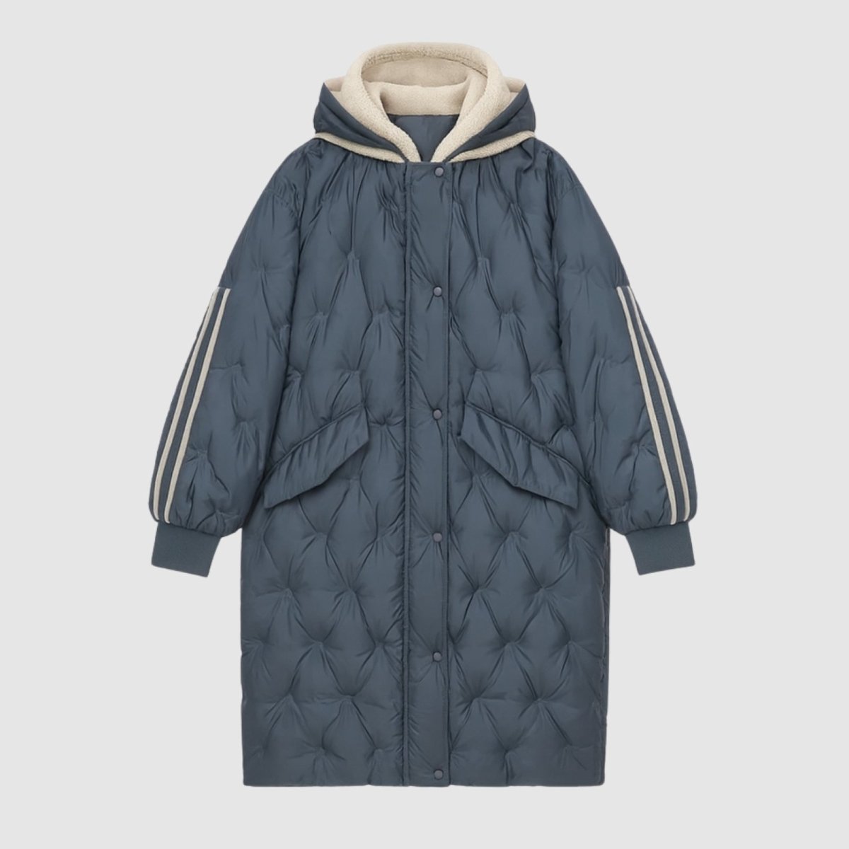 Product shot of the Kouvr Fashion Meridian long quilted down parka in slate dark blue, laid flat to show front details and pockets.