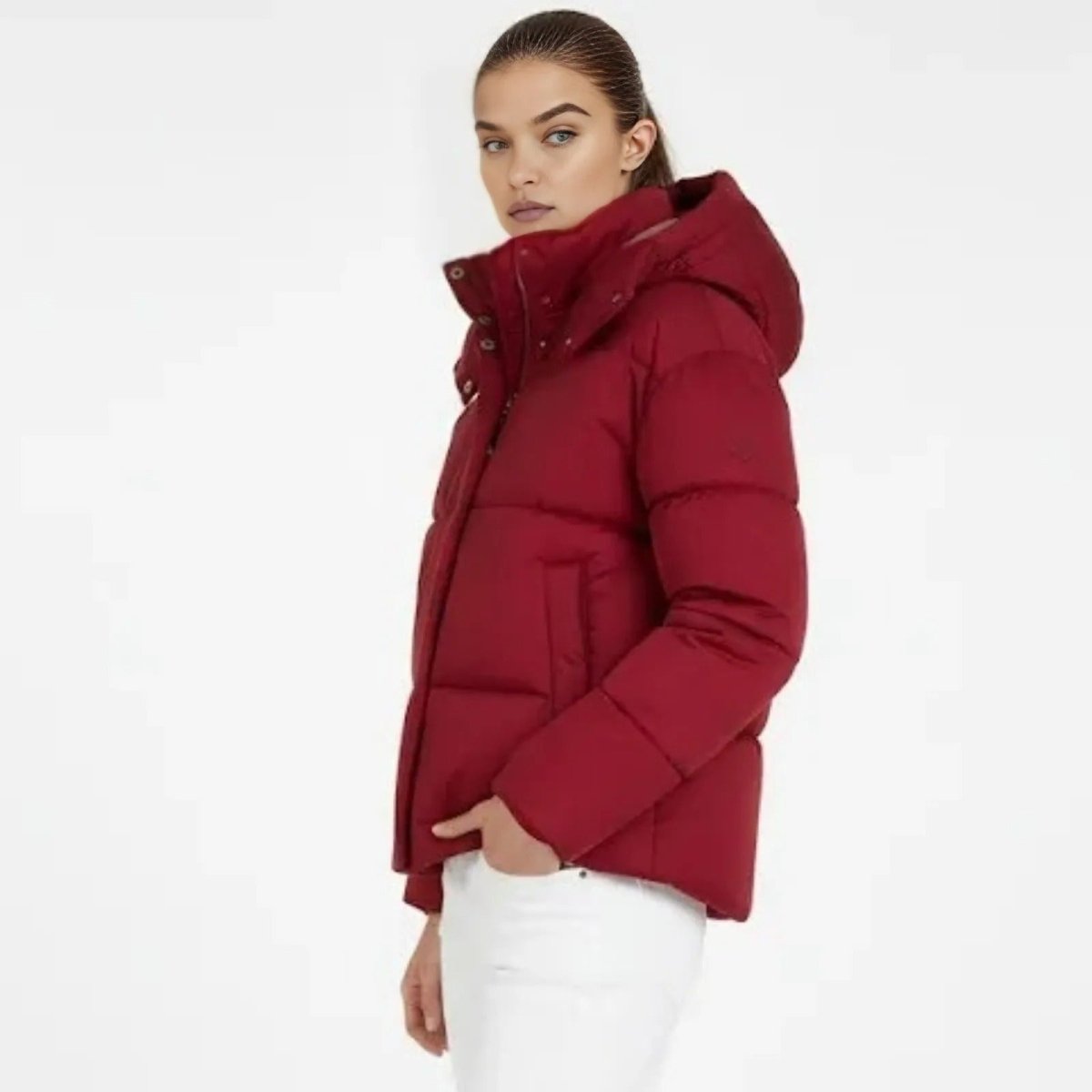 Side profile of a model in the crimson red Miranda puffer jacket by Kouvr Fashion, showing the boxy fit and insulated hood.
