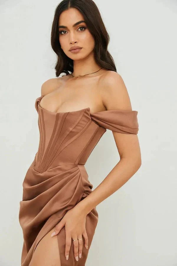 Model wearing Kouvr Fashion mocha brown off-the-shoulder satin corset dress with draped skirt and thigh slit