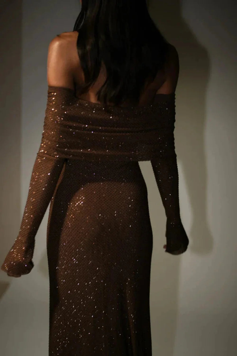 Model wearing Kouvr Fashion long sleeve off-the-shoulder brown sequin formal gown