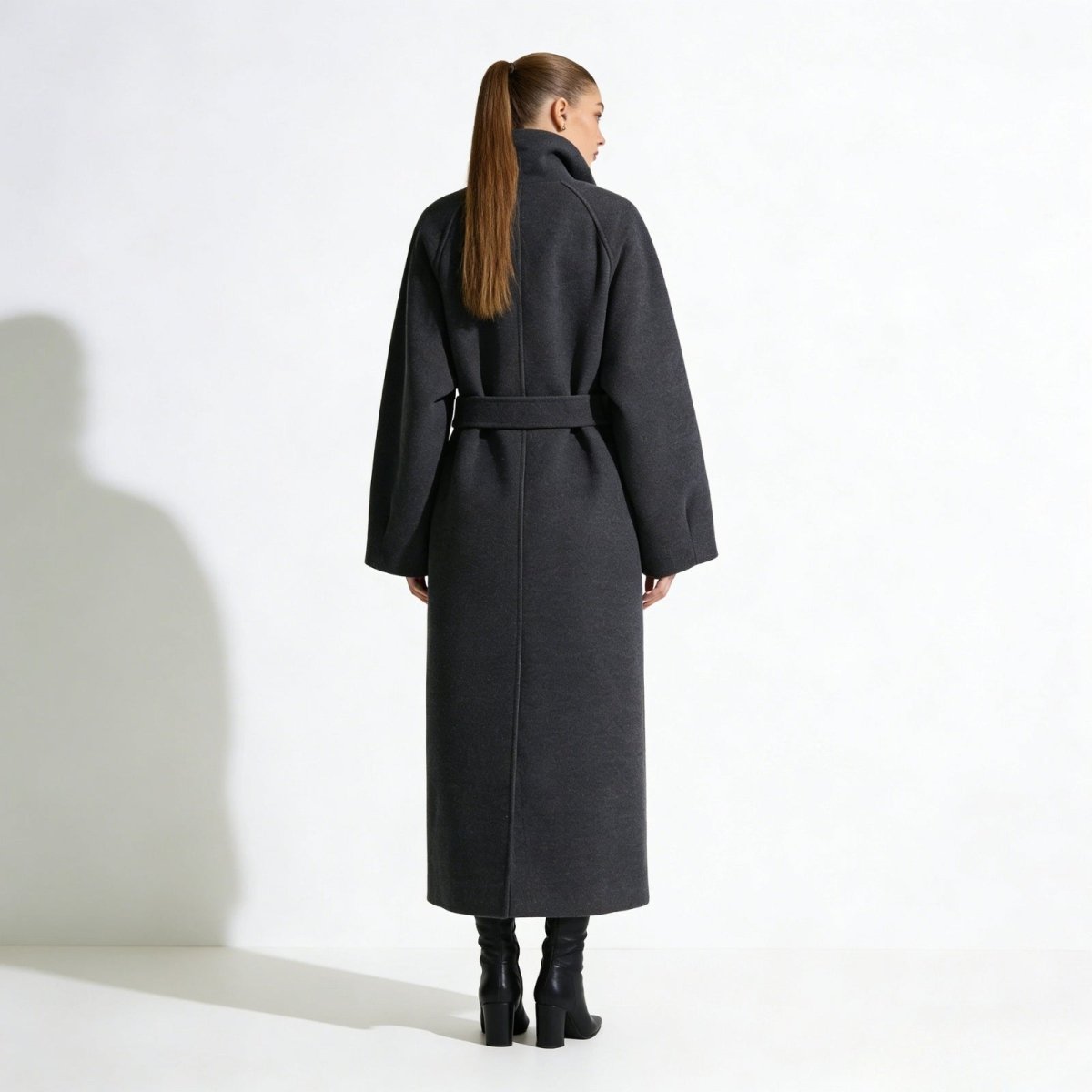 Back view of the Kouvr Fashion Patrice long belted wool coat in gray, showing the clean lines and oversized fit on a model.