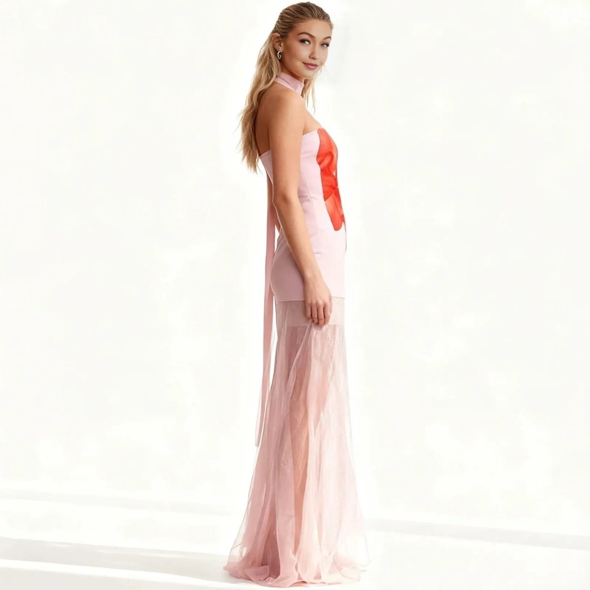 Woman wearing a pink and red Kouvr dress on a white background