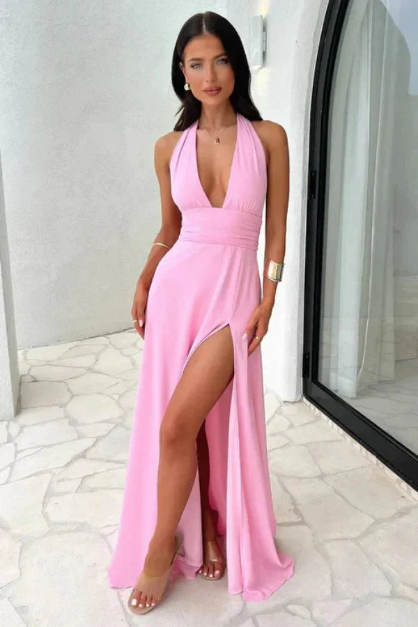 Model wearing the Kouvr Fashion pink backless halter neck maxi dress with a thigh-high slit, front view.' and 'Rear view of the Kouvr Fashion pink maxi dress showing the open back and tie details
