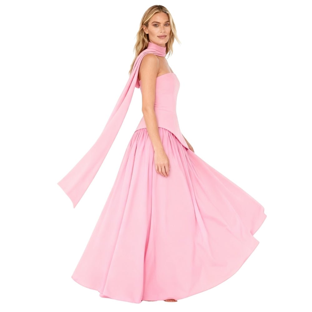 Woman wearing a Pink Kouvr dress with sheer sleeves on a white background