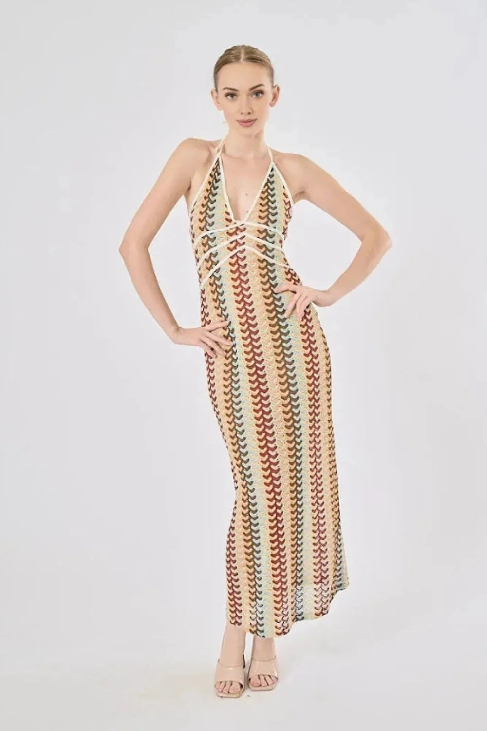 Model viewed from the back wearing the Kouvr Fashion 70s-inspired retro wave print halter maxi dress, showcasing the open-back design