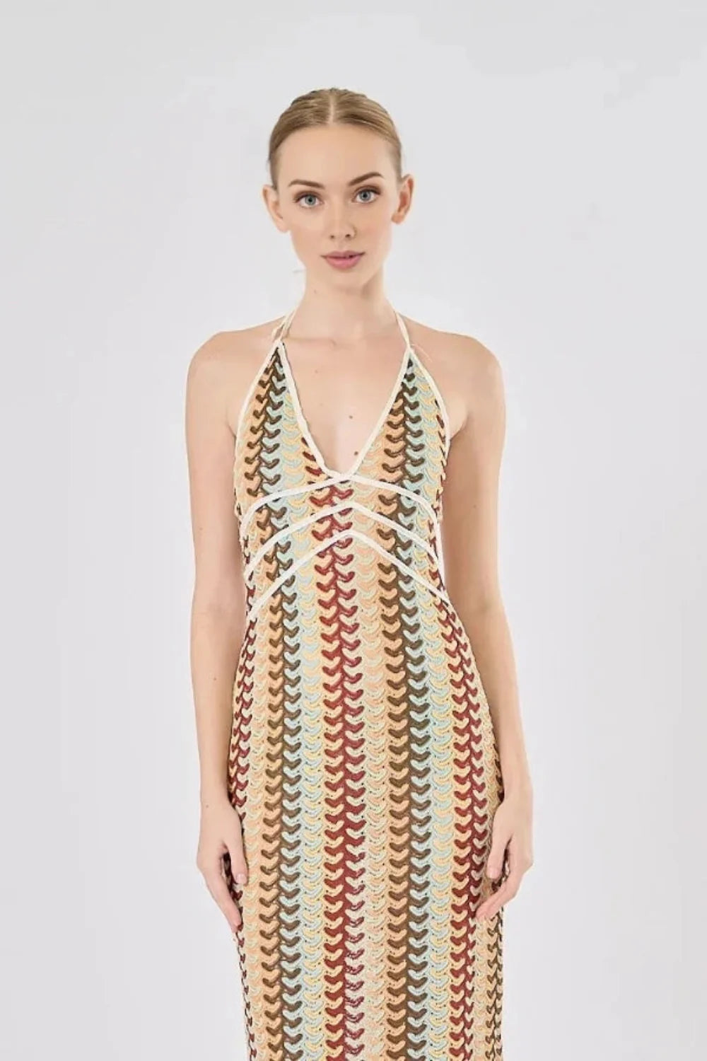 Model viewed from the back wearing the Kouvr Fashion 70s-inspired retro wave print halter maxi dress, showcasing the open-back design