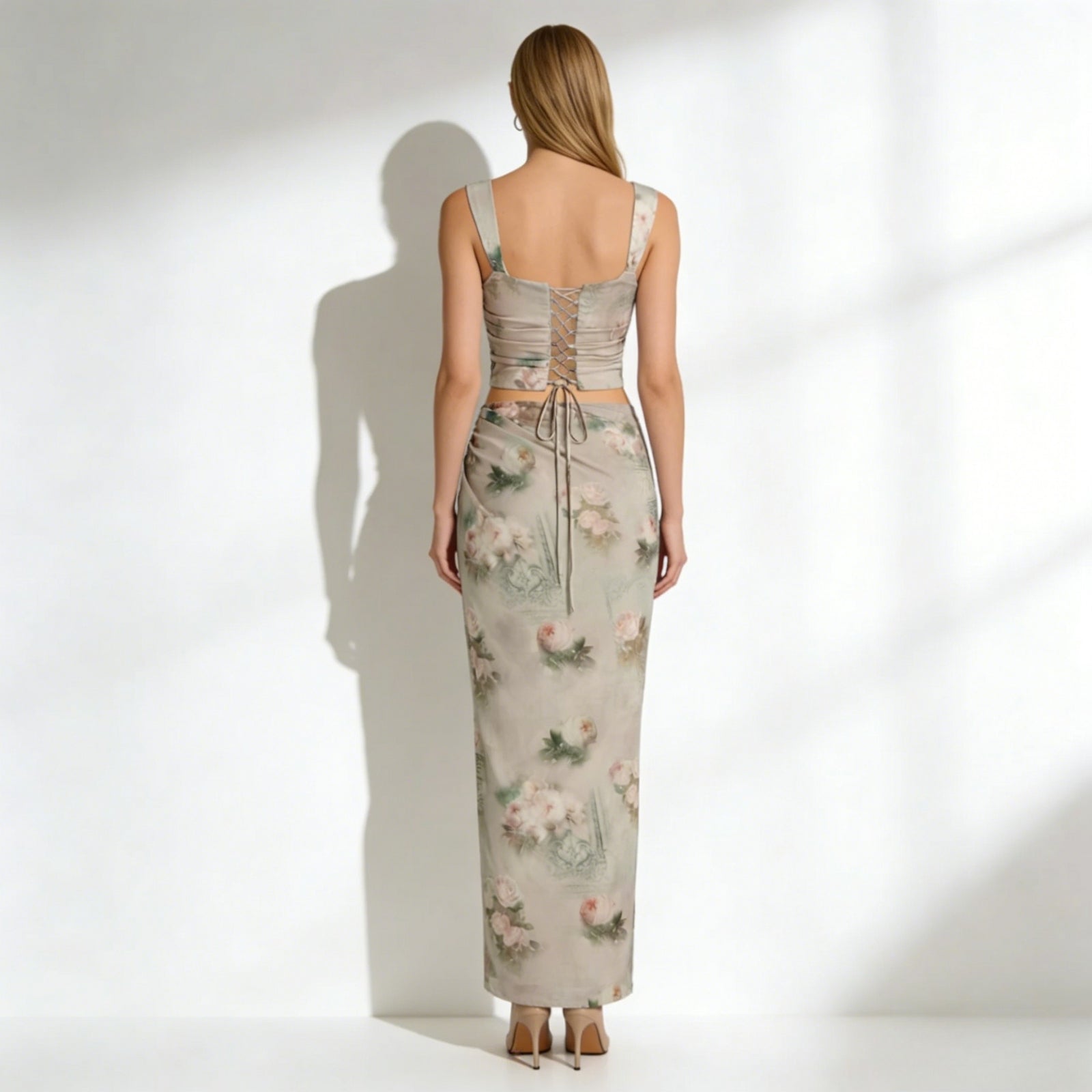 Back view of the Kouvr Fashion Rona set, highlighting the adjustable lace-up detail on the corset top and the full length of the maxi skirt.