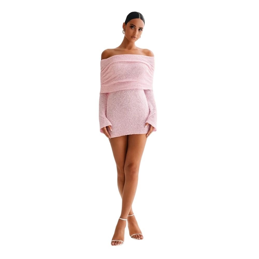 Woman wearing a pink kouvr off-shoulder top and skirt set on a white background