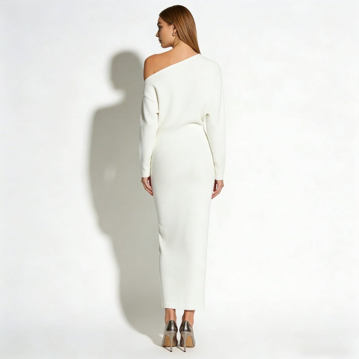 Back view of a model in the Kouvr Fashion Selena off-the-shoulder white knit evening gown.