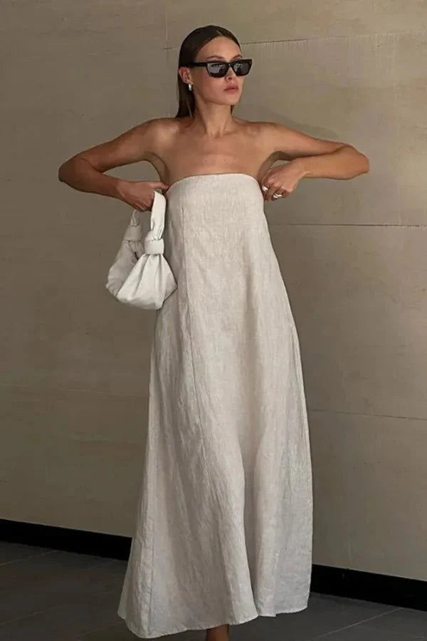 Model from behind wearing the Kouvr Fashion strapless linen maxi dress showing the smocked back detail