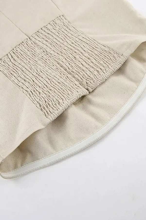 Model from behind wearing the Kouvr Fashion strapless linen maxi dress showing the smocked back detail