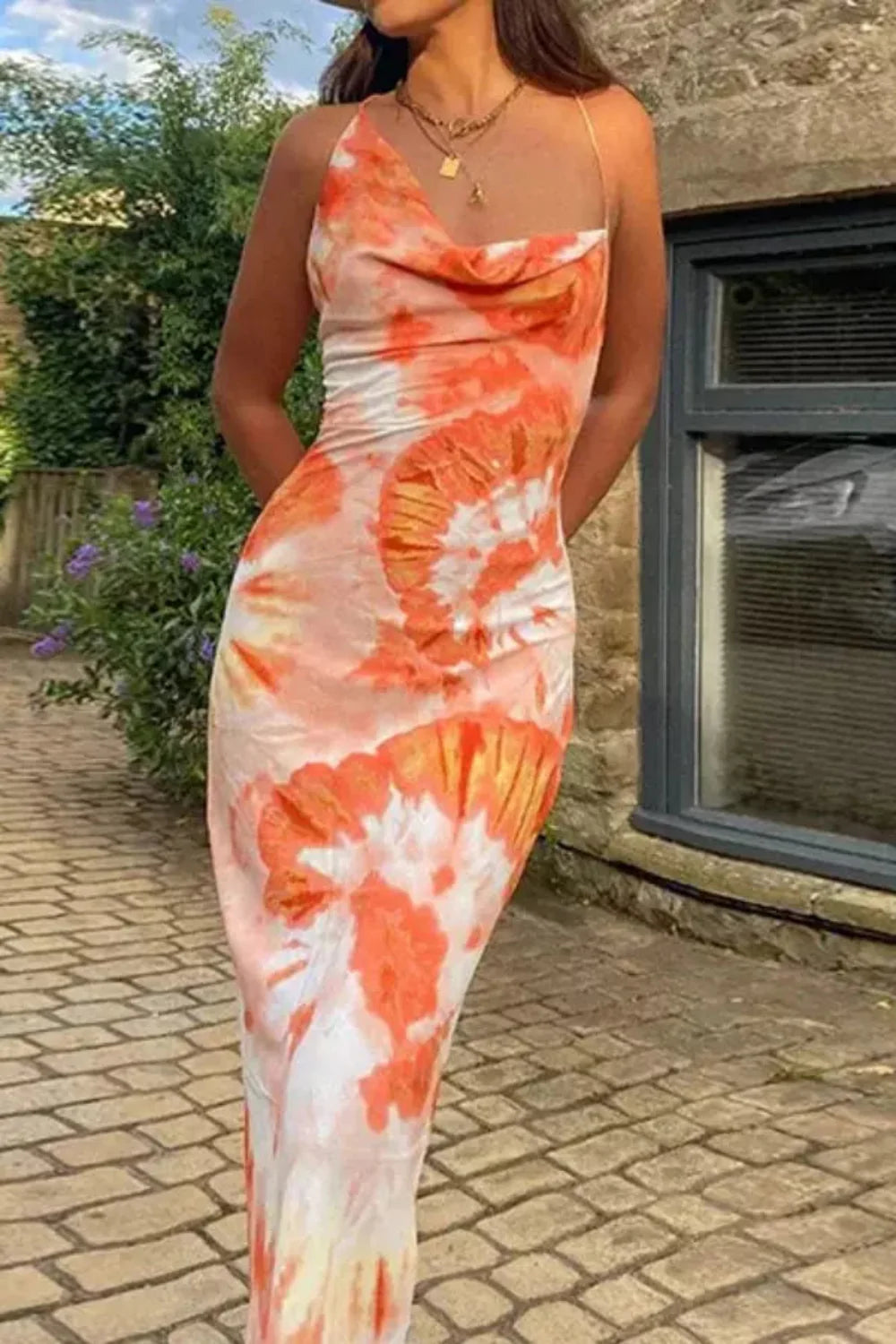 Model wearing the Kouvr Fashion Sunset Orange Tie-Dye Slip Dress with backless lace-up detail