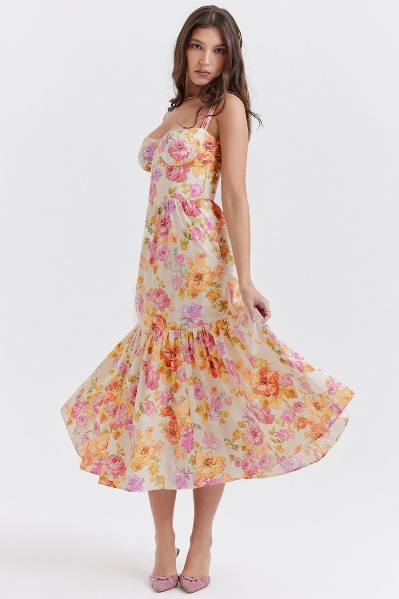 Side profile of a woman in The Persephone floral bustier midi dress, highlighting the A-line silhouette and tiered hem.