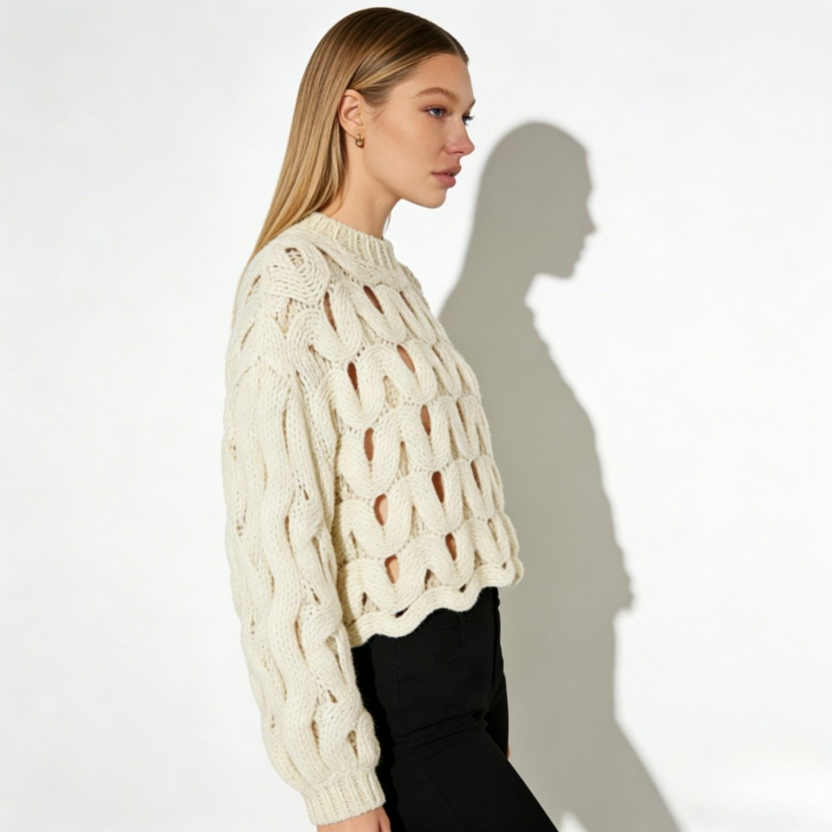Side view of a model in the Kouvr Fashion Vanice sweater, highlighting the balloon sleeve silhouette and cropped length.