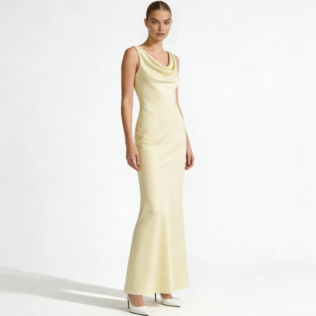 Model wearing the Kouvr Fashion Vickie Gown in Ivory, a sleeveless cowl neck satin maxi dress, viewed from the front against a white background.