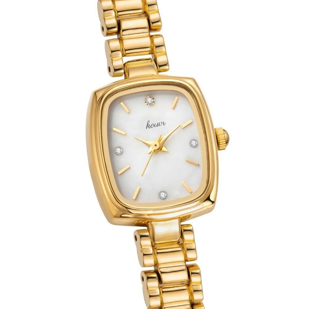 Gold Kouvr wristwatch with a white face on a white background