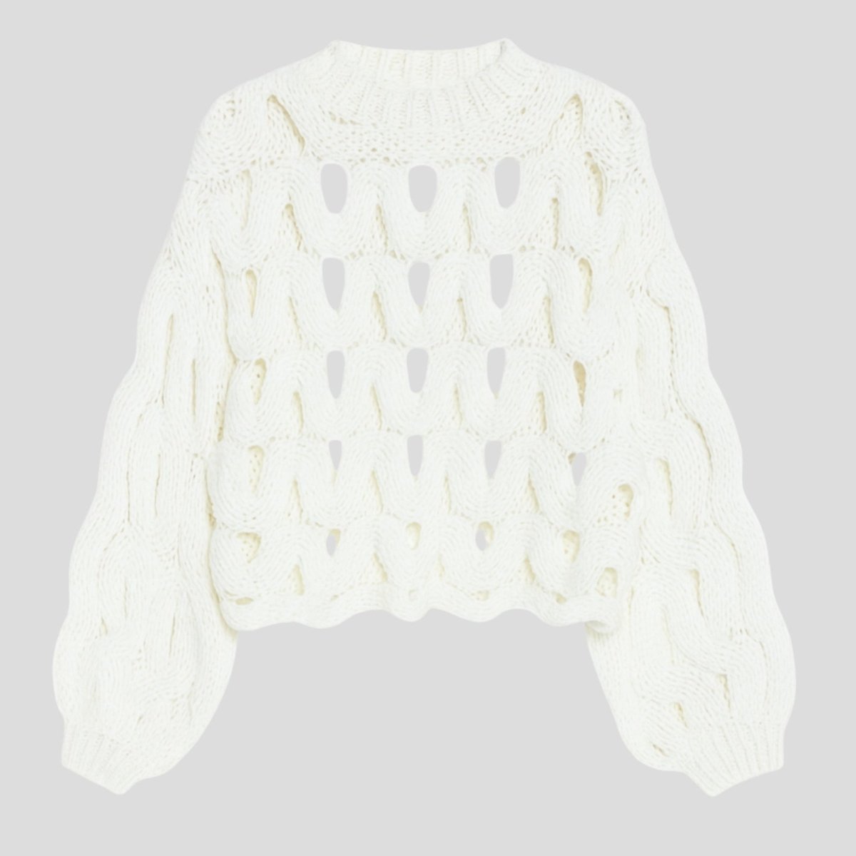 Flatlay product shot of the Kouvr Fashion white cutout chunky knit sweater, front side, on a light grey background.