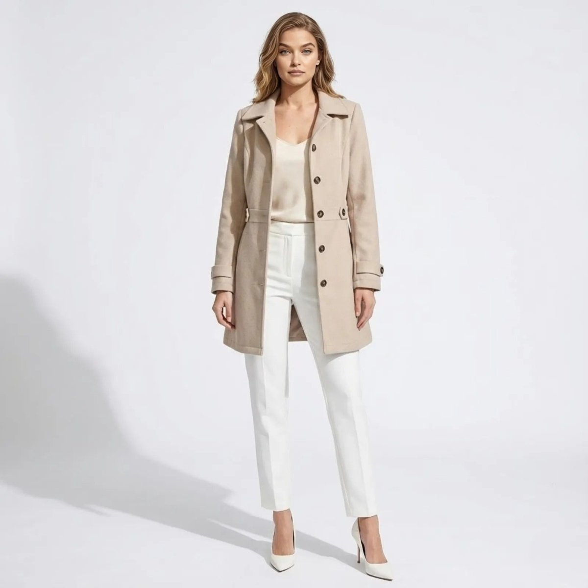 Model wearing the Kouvr Fashion women's beige belted wool-blend car coat, styled with white trousers and a cream top, full front view.