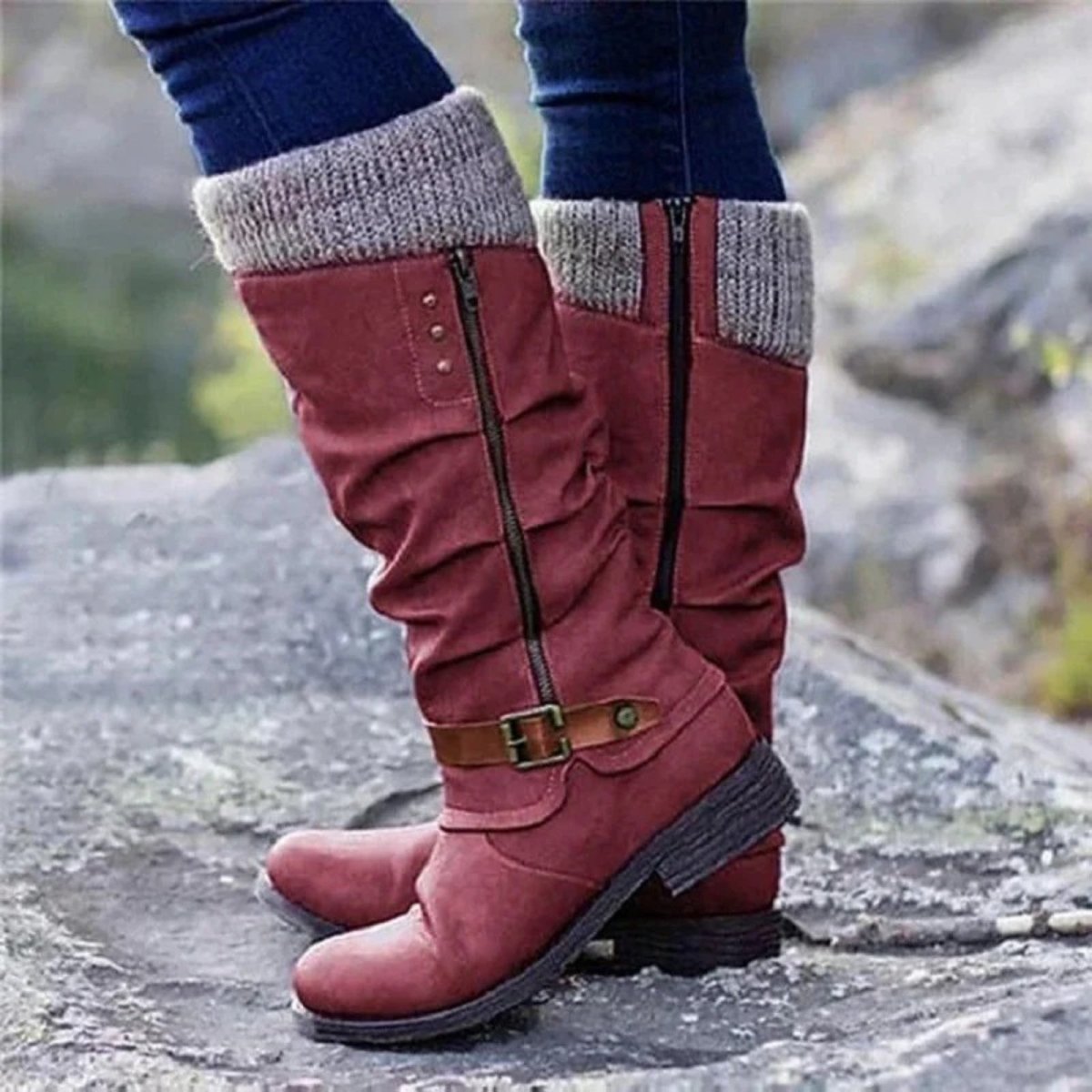 A woman wearing the burgundy red version of the Kouvr Fashion laura knee-high boots with knit cuffs outdoors.