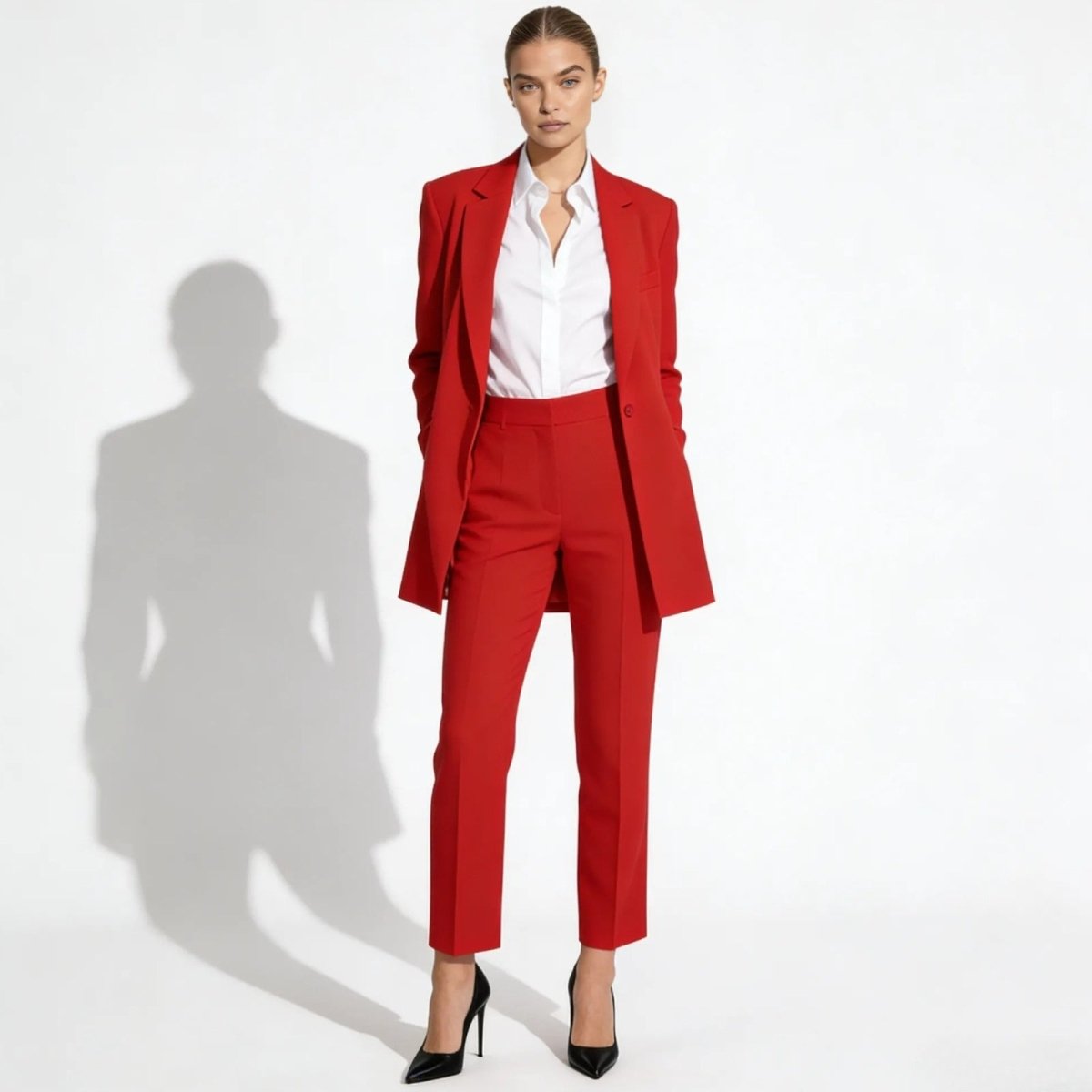 Model wearing the Kouvr Fashion kate red power suit with a white shirt and black heels, standing against a white background.