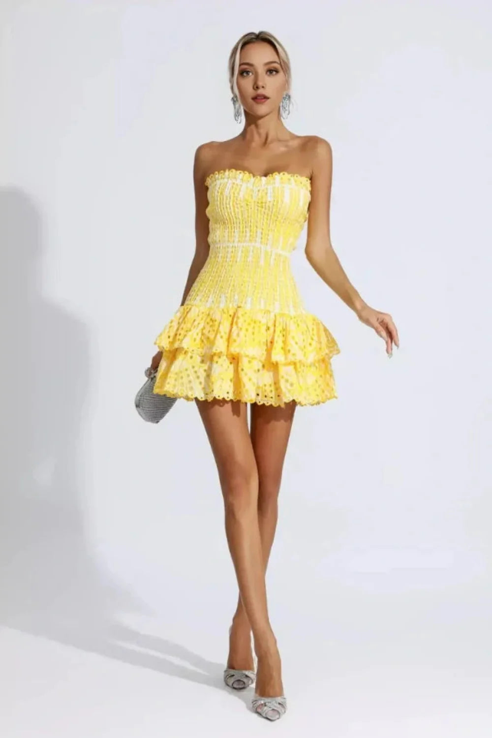 Model wearing Kouvr Fashion strapless yellow eyelet mini dress with tiered ruffle skirt