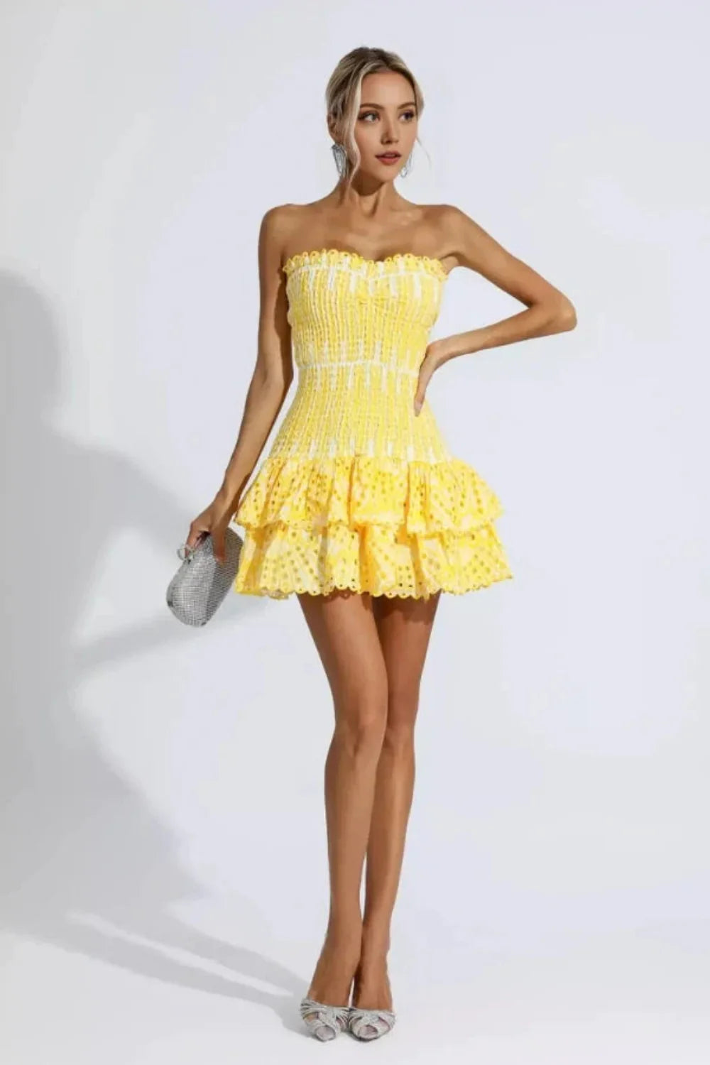 Model wearing Kouvr Fashion strapless yellow eyelet mini dress with tiered ruffle skirt